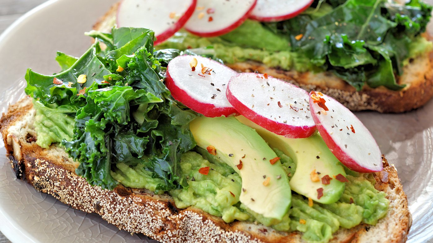Avocado toast with greens, chili flakes and sliced beets