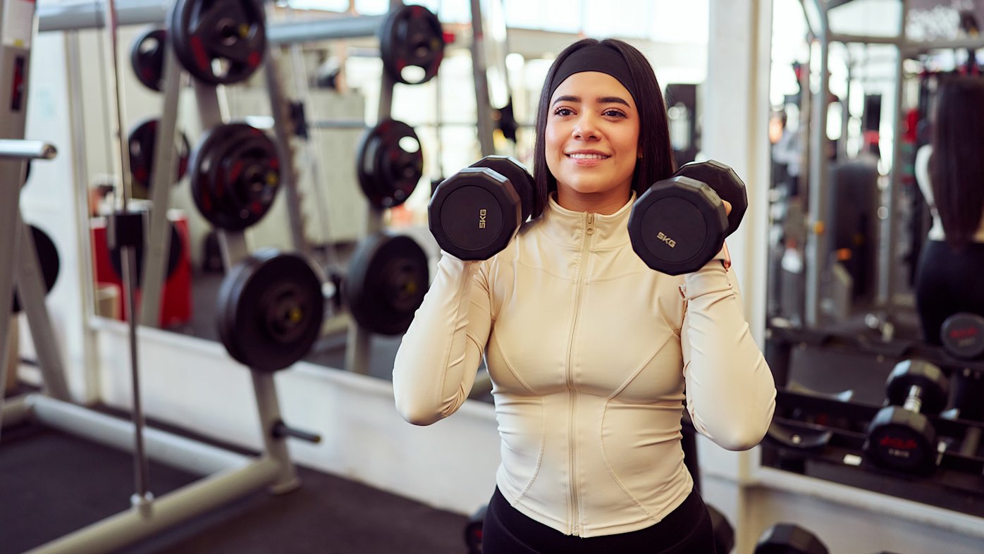 Woman in gym doing weight training