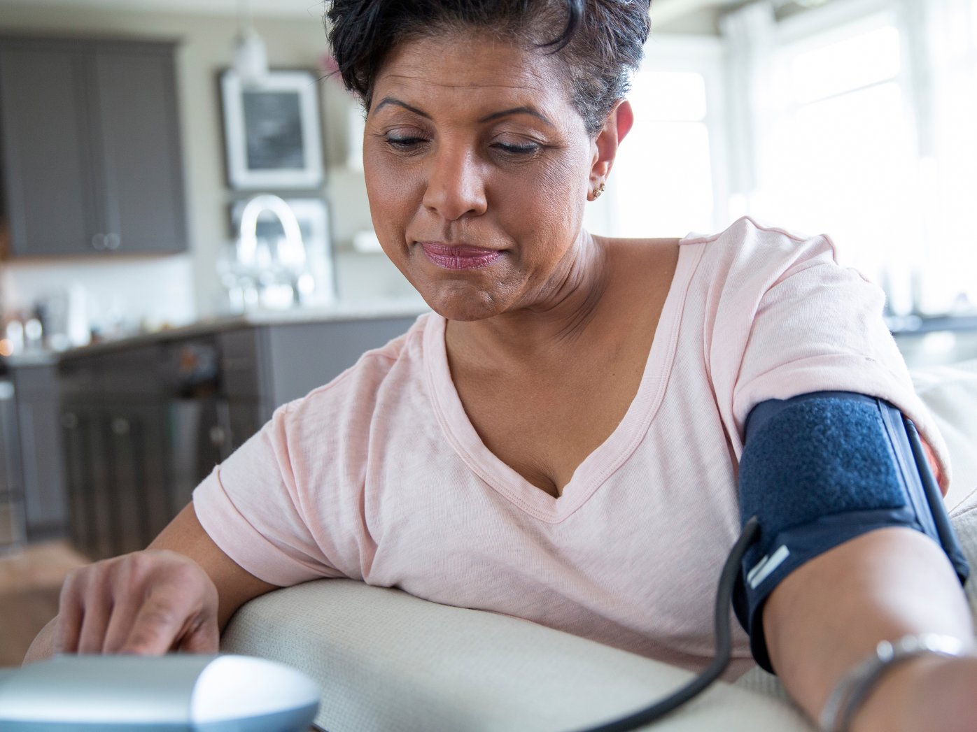 Person taking blood pressure at home