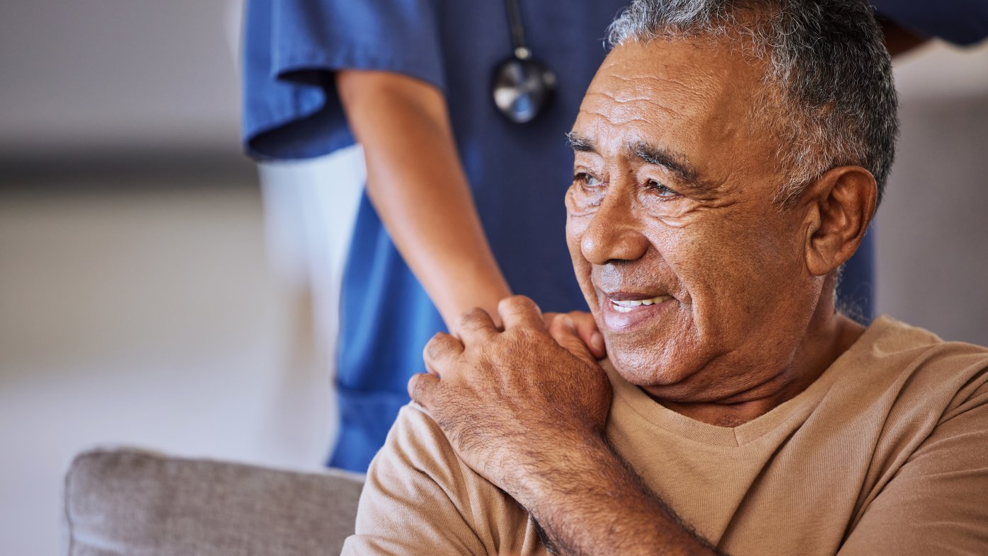 Supportive caregiver's hand on patient's shoulder