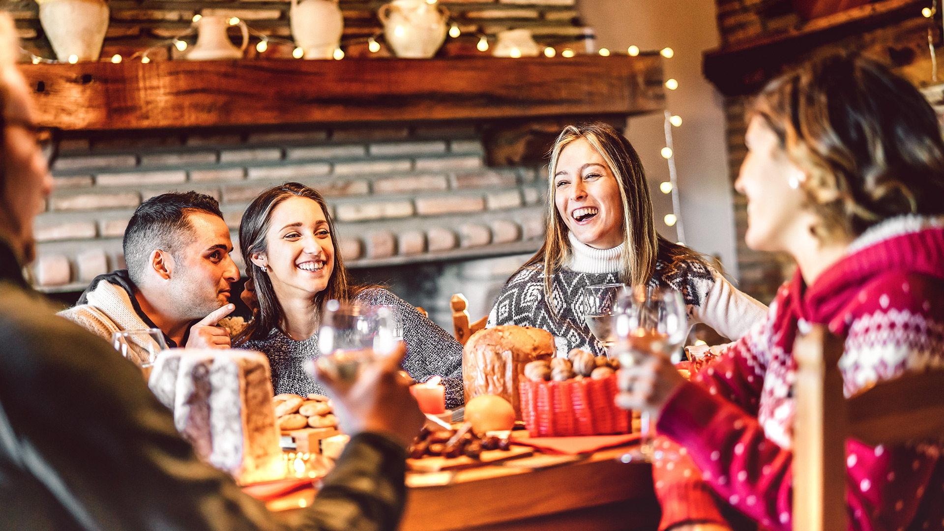 Friends celebrating the holidays around the dinner table
