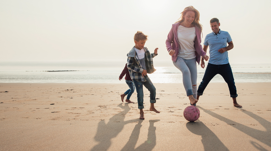 Family playing on the beach