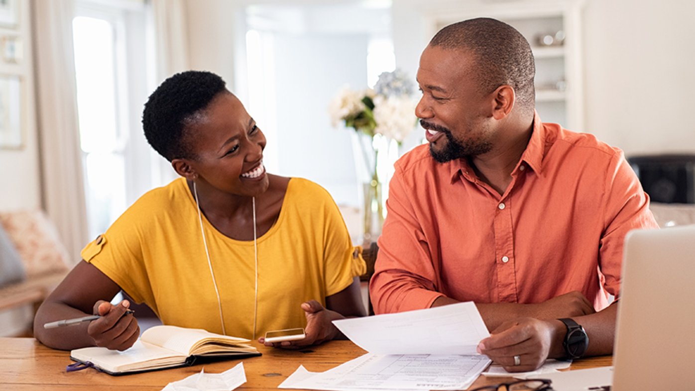 Husband and wife looking at paperwork together