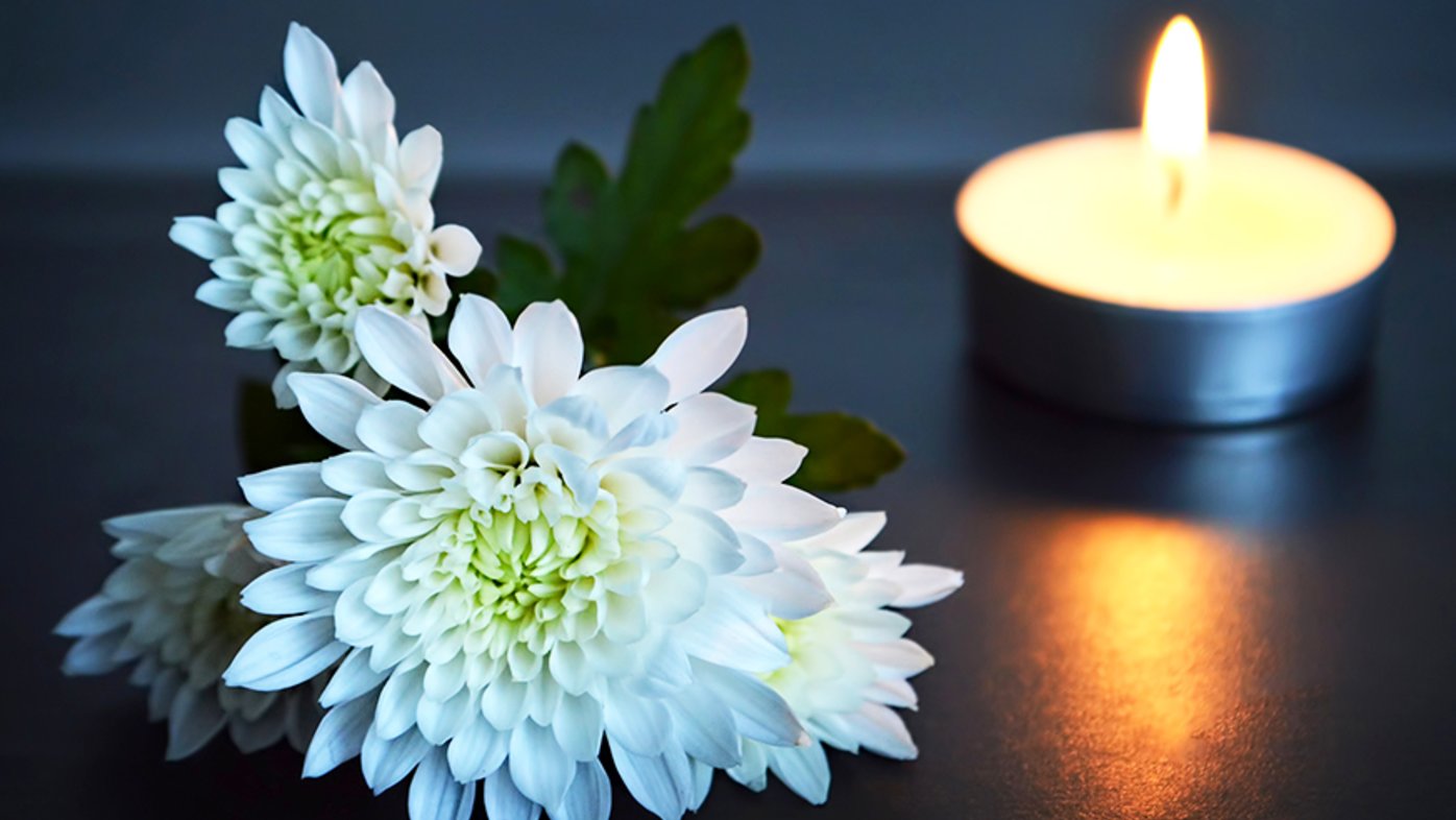 White flowers and lit candle