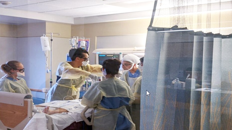 A team in the medical intensive care unit (MICU) at Sharp Chula Vista Medical Center practices the manual patient proning procedure.