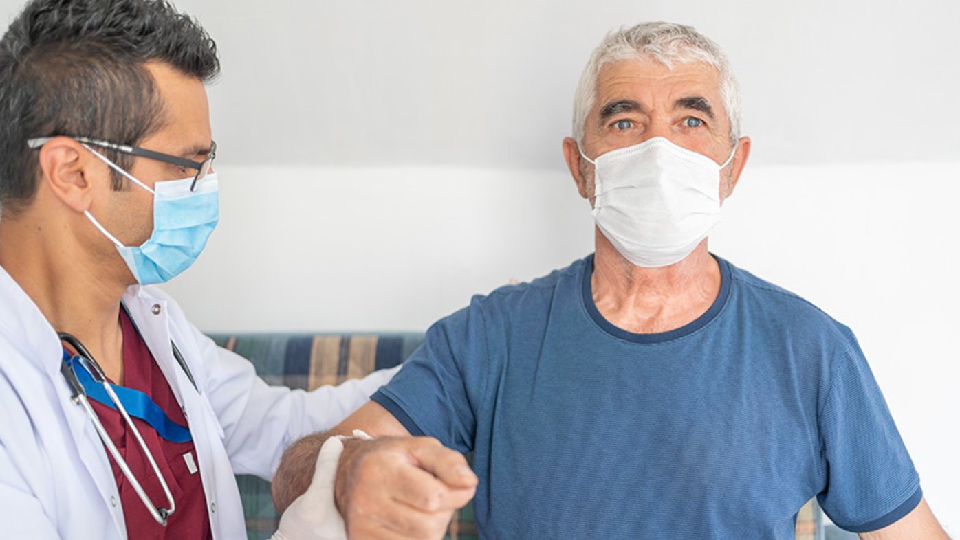 man with protective face mask is having physical therapy