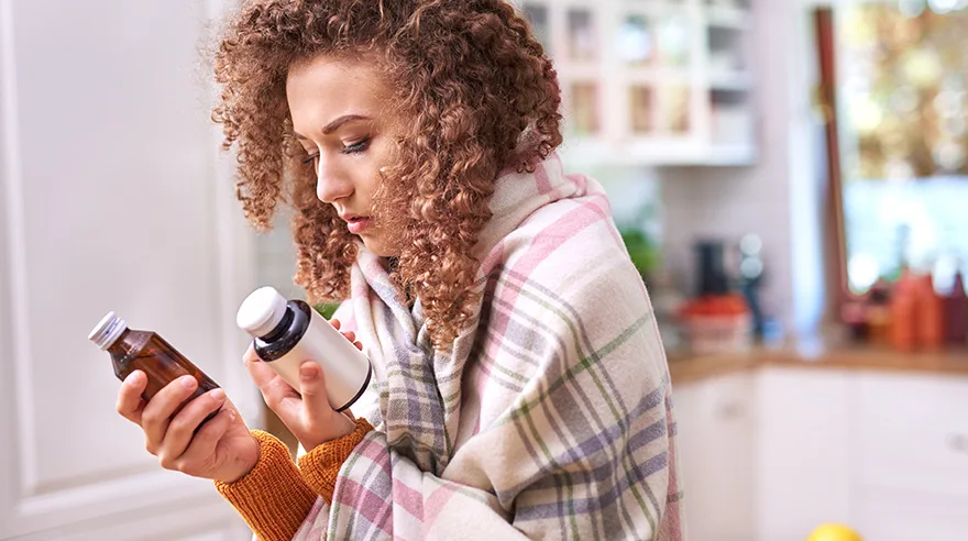 Young woman taking medicine