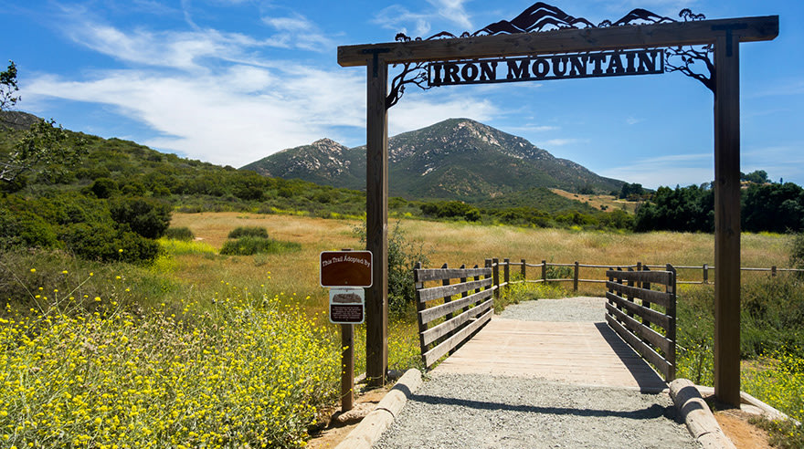 Iron Mountain hiking sign with path and mountain in background