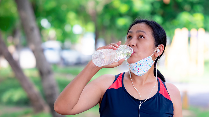 Woman drinking from water bottle