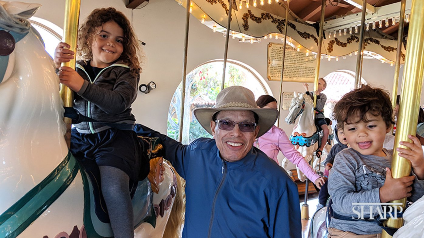 Harold Rucker at the merry-go-round with his grandkids.