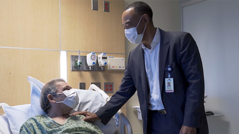 David Ponder (l) spends a moment with transplant surgeon Marquis Hart, MD.