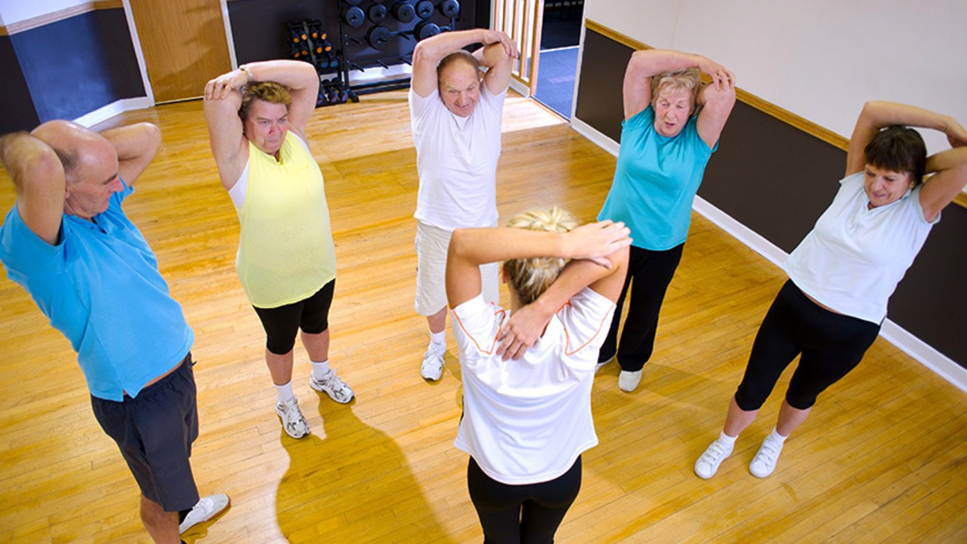 Older adults stretching at a class