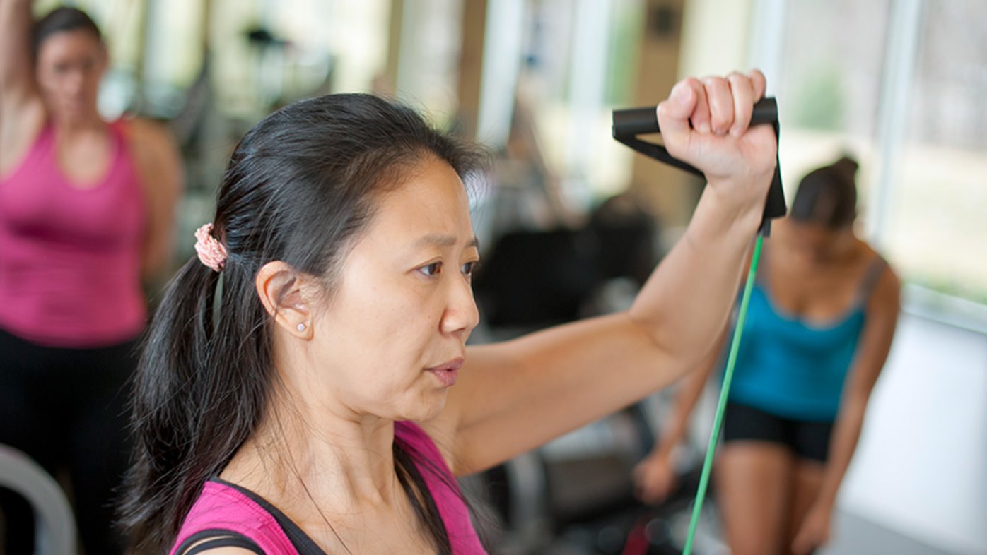 Woman stretching in gym.