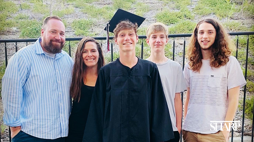 Ethan Roche (center) and his father, Steven (far left), pictured with the rest of his family.