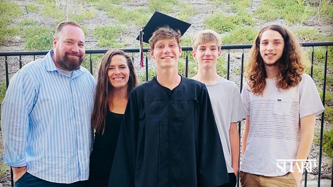 Ethan Roche (center) and his father, Steven (far left), pictured with the rest of his family.
