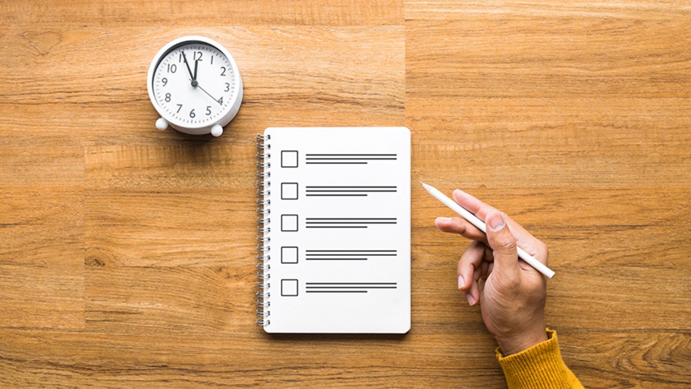 Checklist on a notepad with a clock