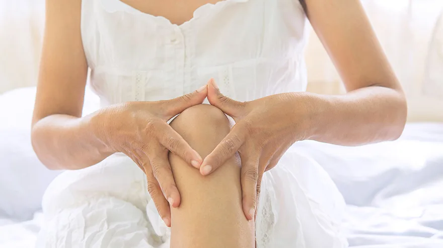 Woman holding her knee in pain