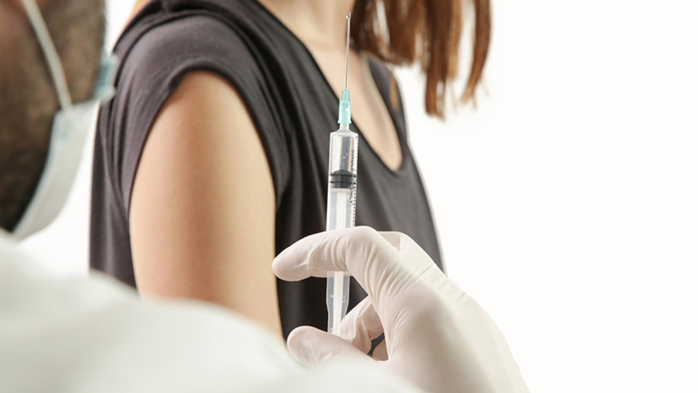 Woman getting flu shot at doctor's office