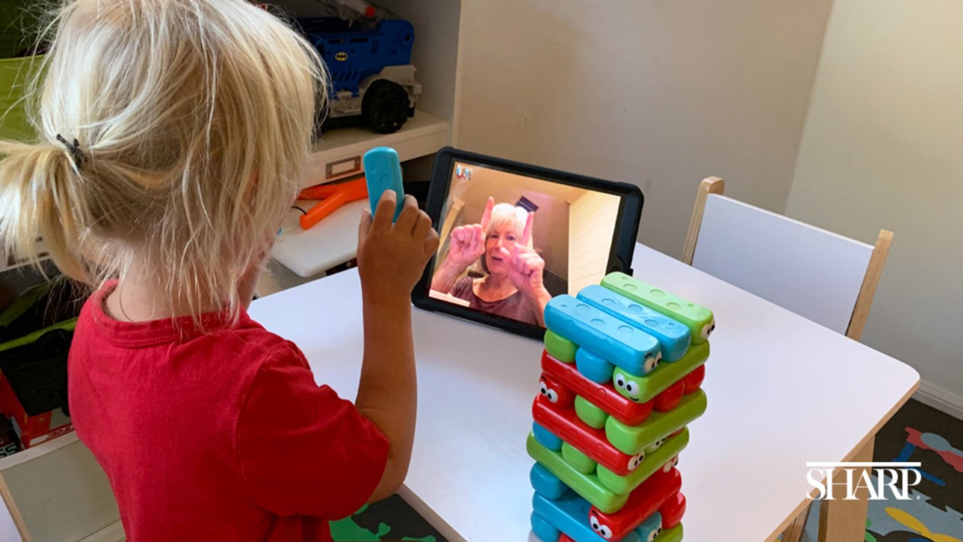 Child on a virtual call with grandmother