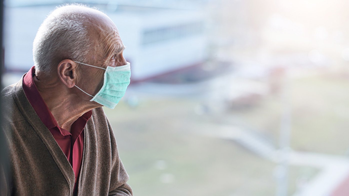 Senior in hospital wearing a mask