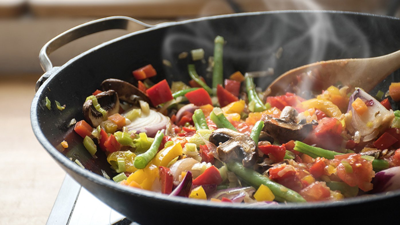 Vegetables cooking in a wok on the stove
