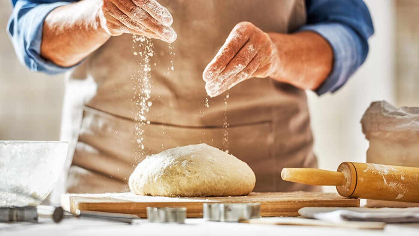 Sprinkling flour on dough