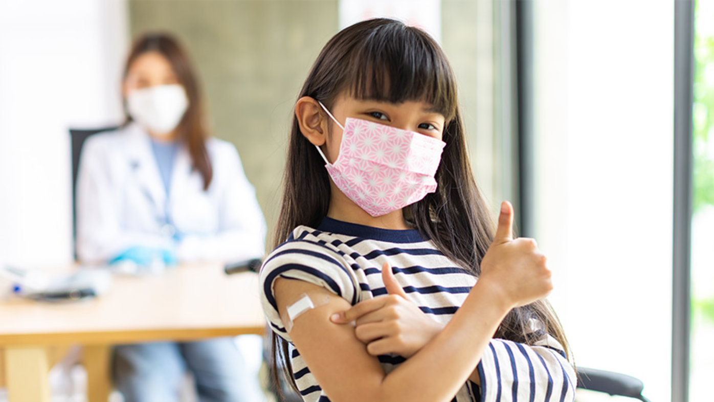 Girl wearing mask getting vaccine