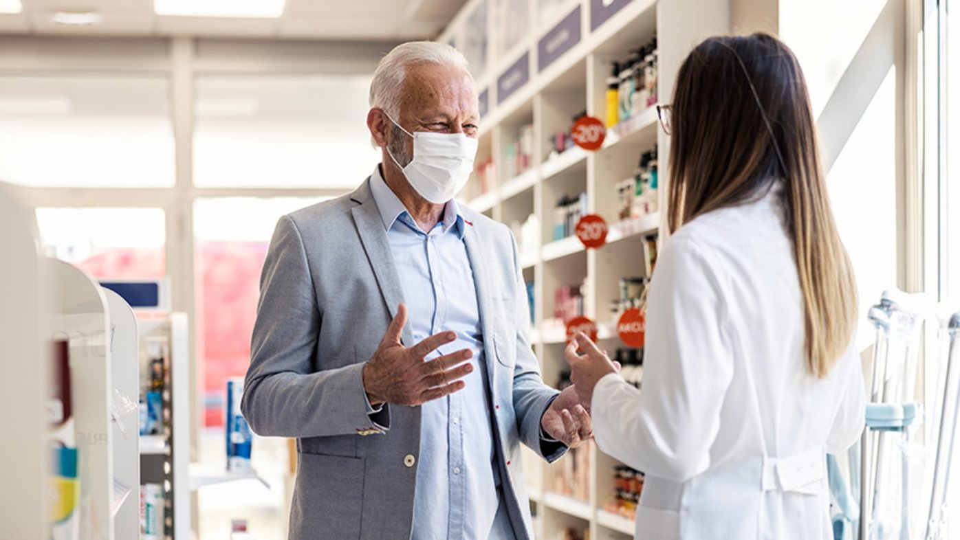 Man speaking to pharmacist