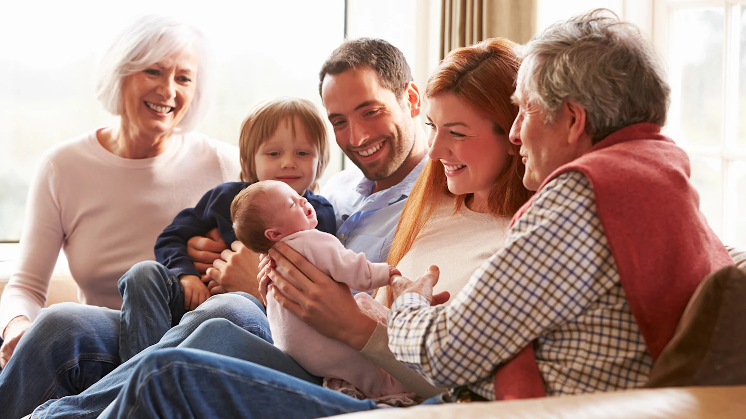Family smiling around new baby