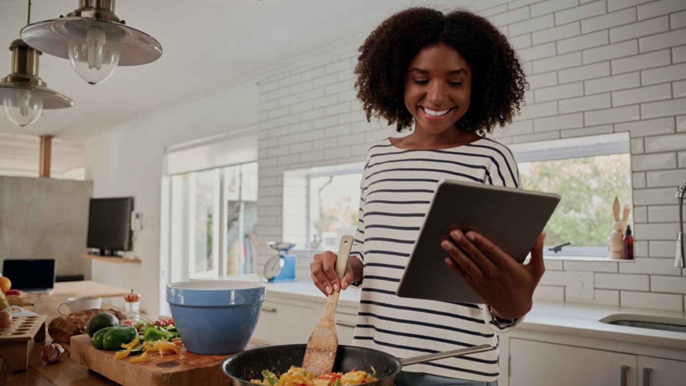 Woman cooking healthy meal in kitchen