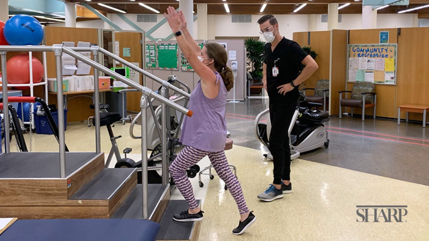 Mason Hearn, PT, demonstrates vestibular ocular reflex (VOR) training with patient Elizabeth Stanton.