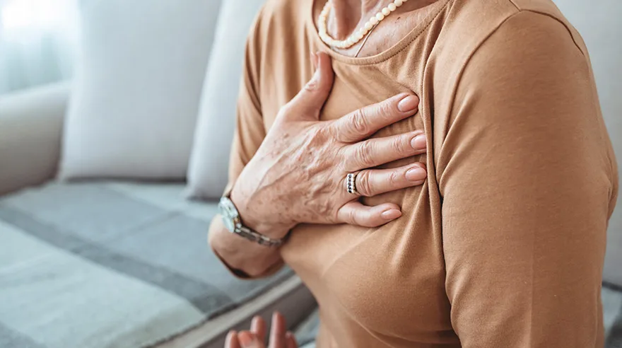 Woman with her hand on her chest