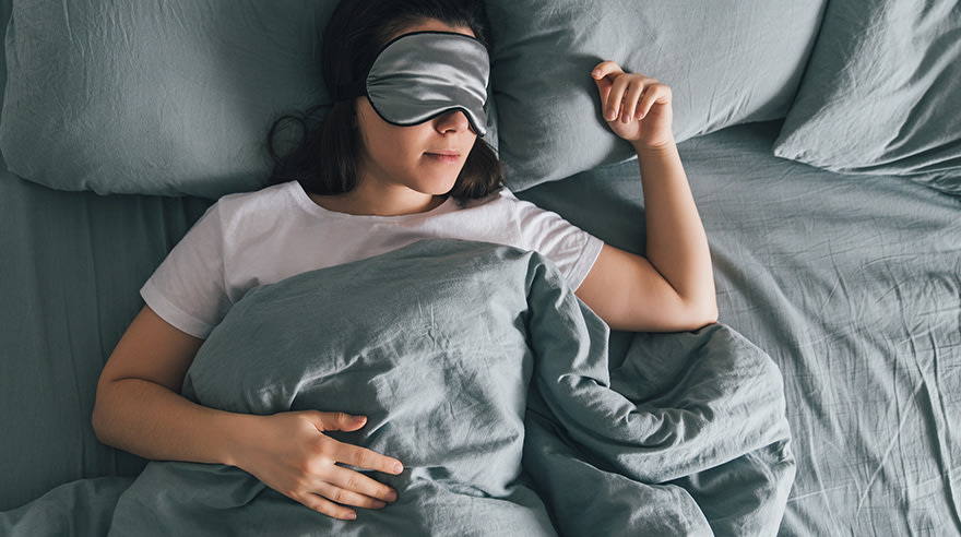 Woman asleep wearing eye mask