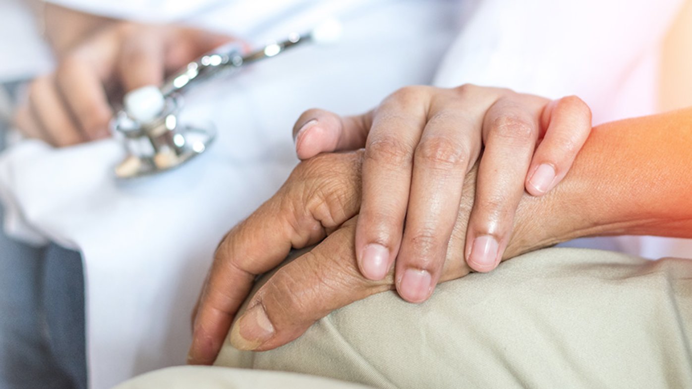 Doctor holding patient's hand