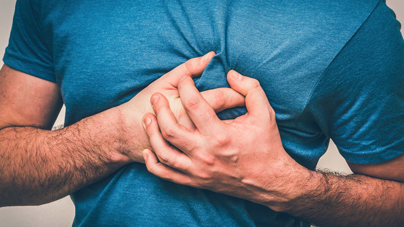 Man clutching his chest from a heart attack