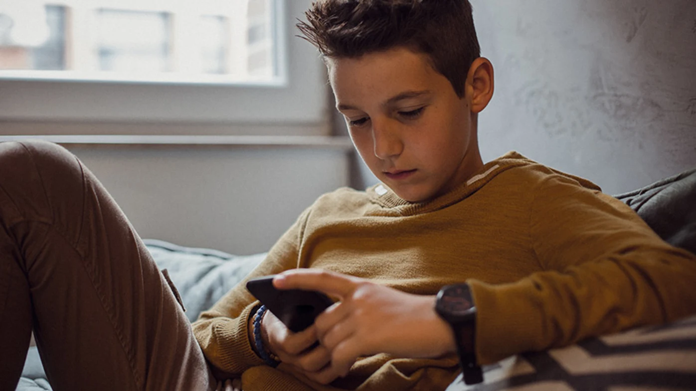 Teenage boy checking phone