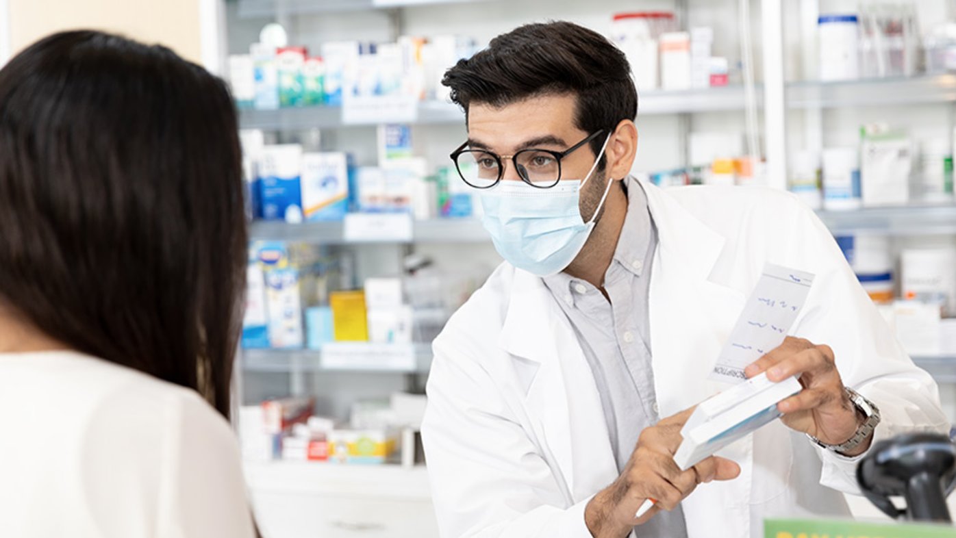 Pharmacist explaining medication to patient