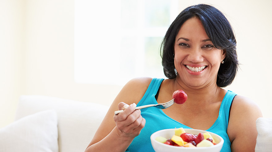 Woman eating fruit bowl