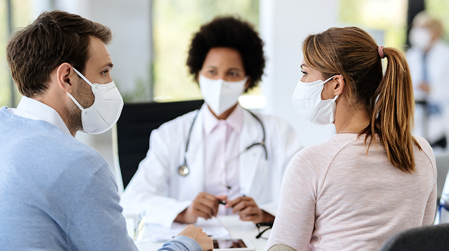 Couple discussing health with doctor