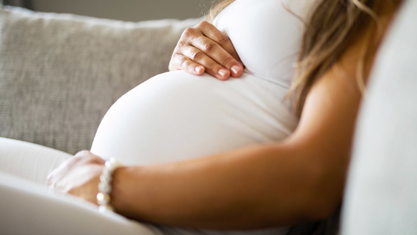 Woman holding pregnant belly