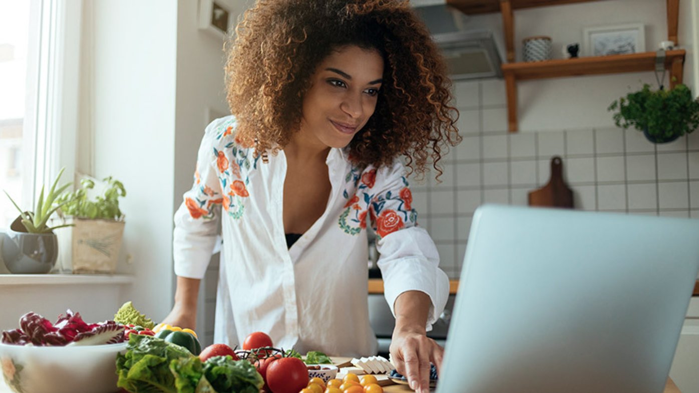 Woman cooking healthy meal in kitchen