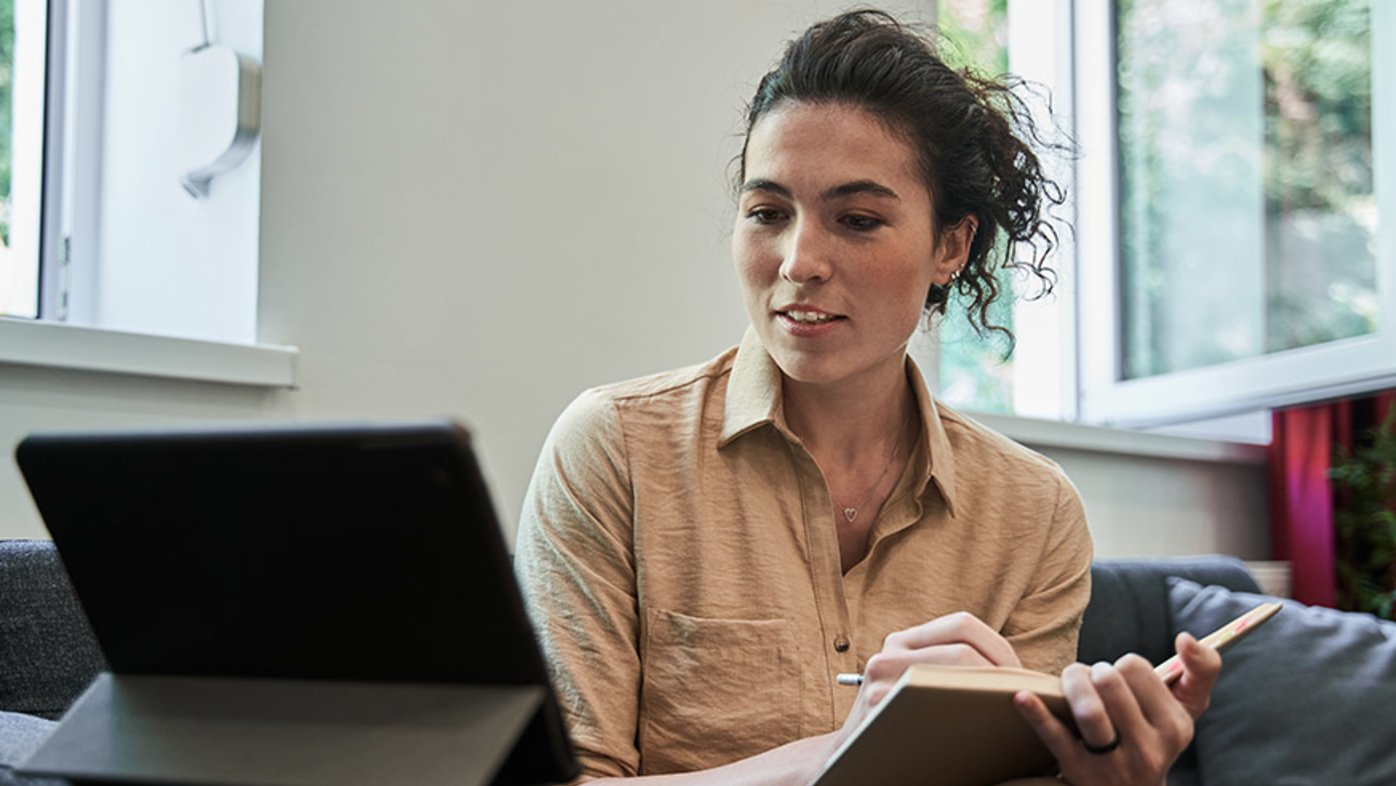 Woman with notebook during video call