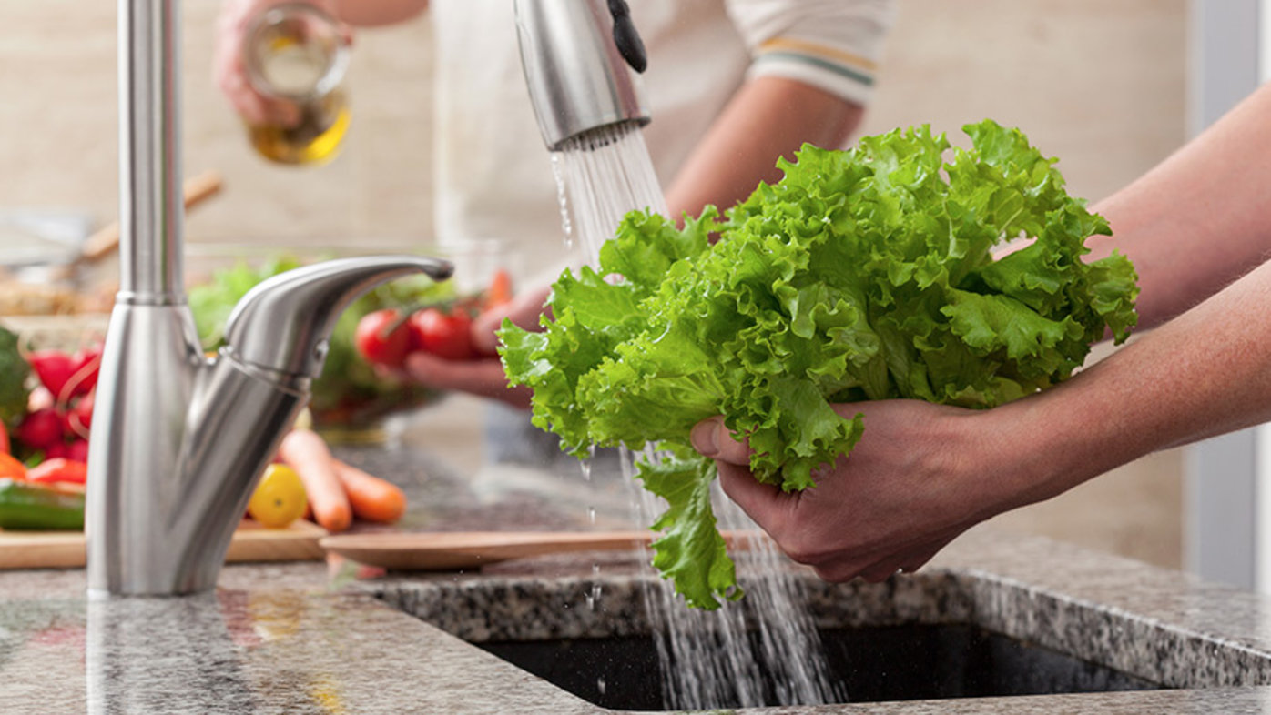Fresh fruits and vegetables being washed thoroughly for safe consumption