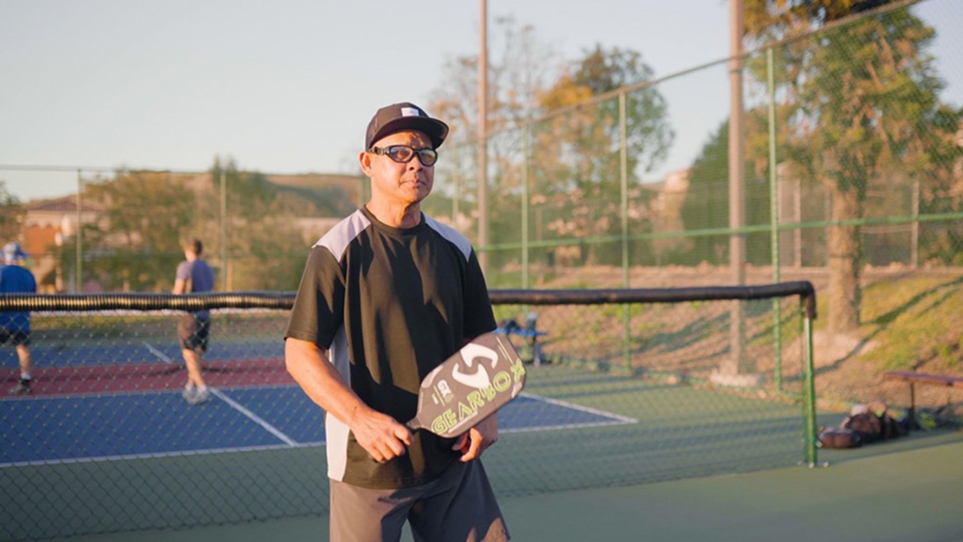 Active man playing pickleball