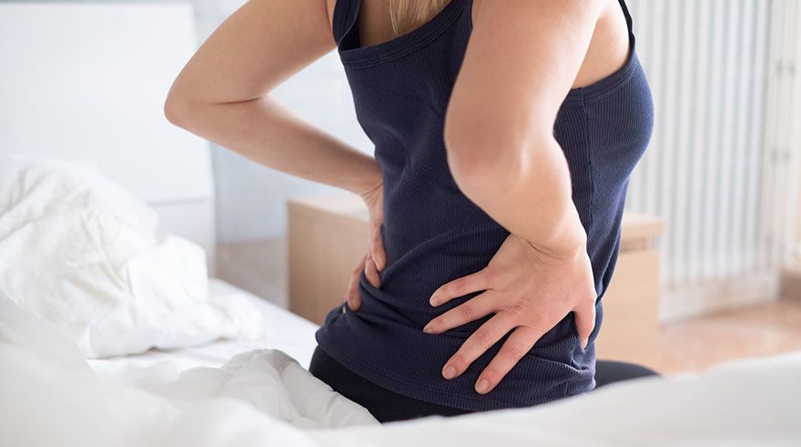 Woman experiencing hip and back pain