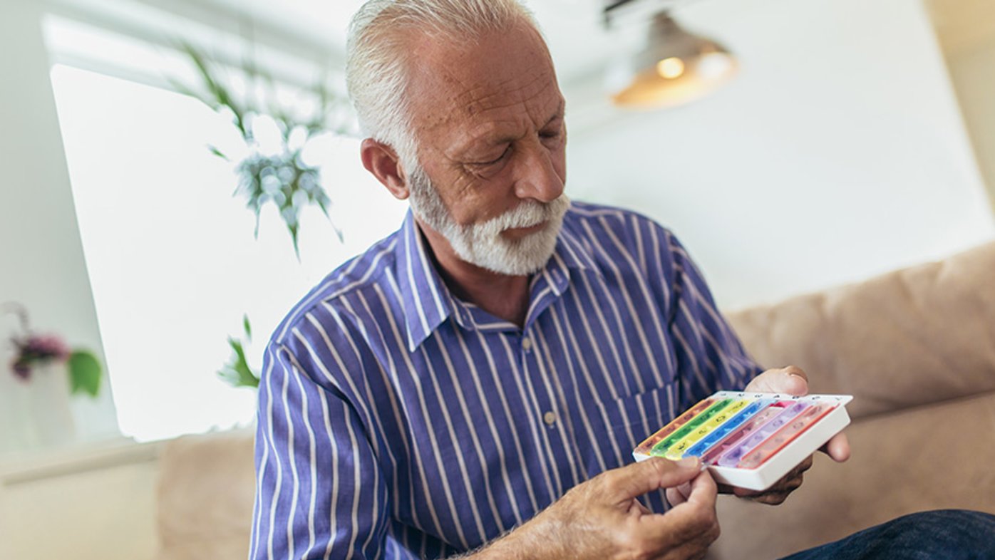 Senior man taking medications