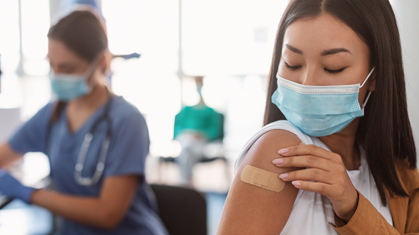 Woman with vaccine bandage