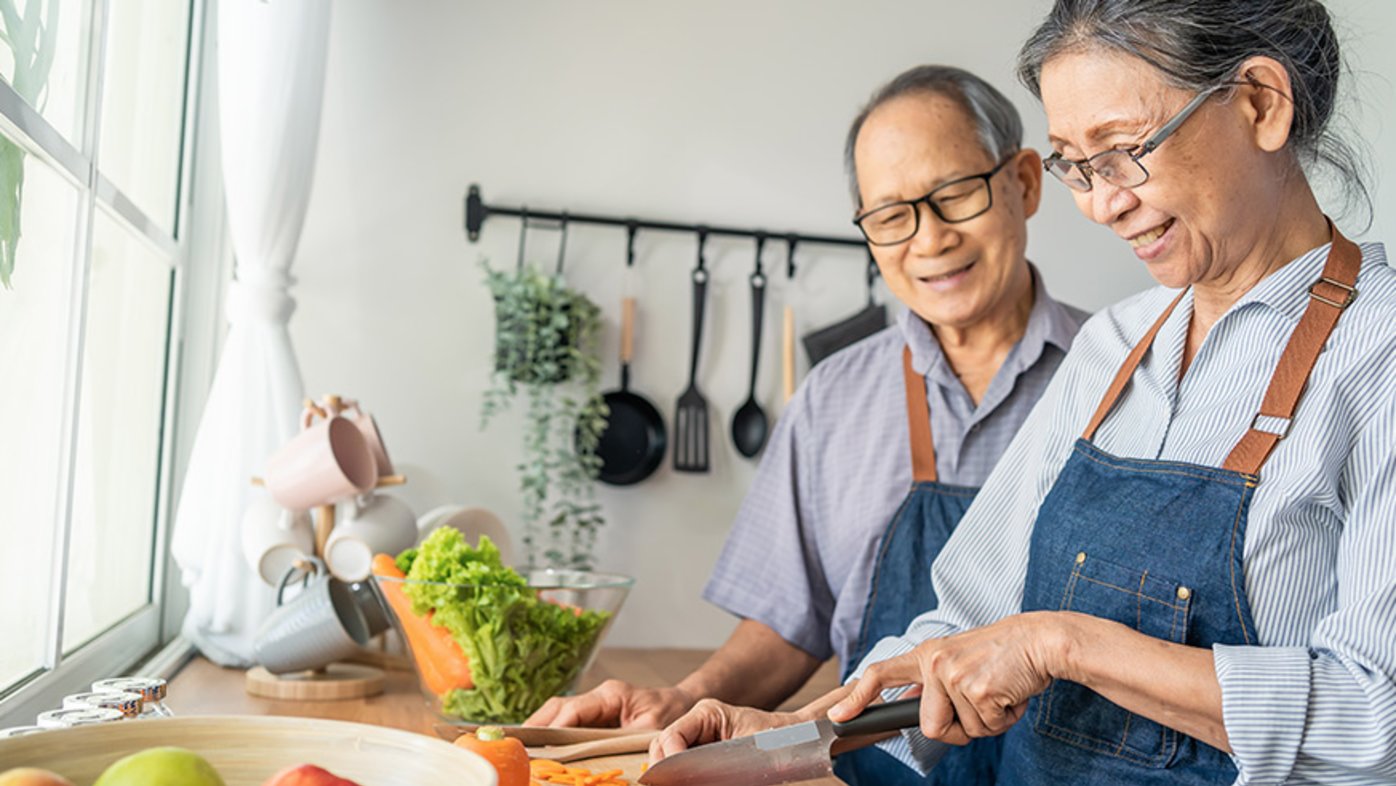 Senior couple cooking in kitchen