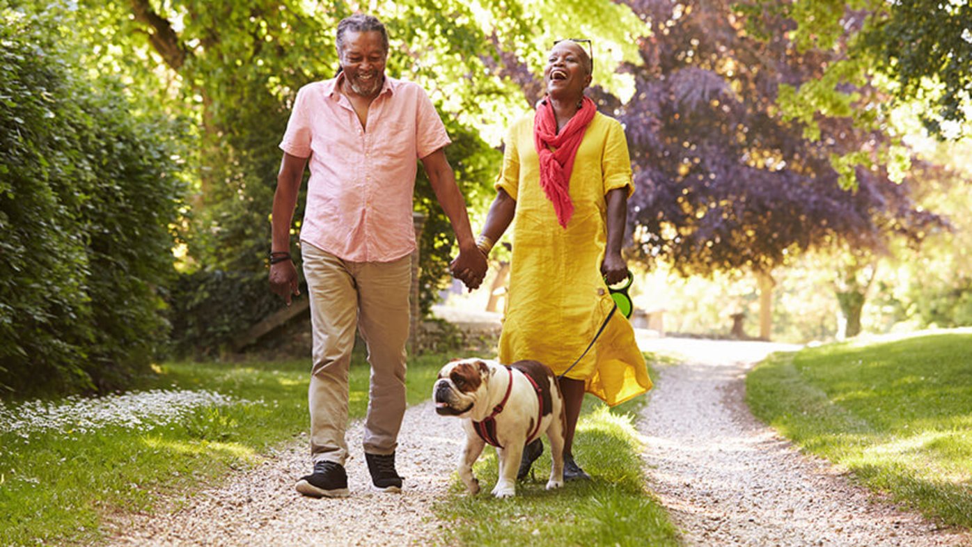 Couple outdoors walking dog