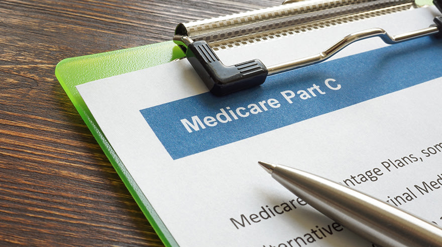 Medicare Part C document on a clipboard